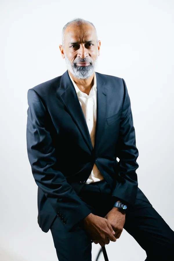 Ashraf Latif, seated, in a dark suit